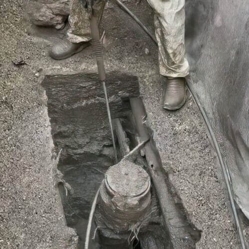 Plumber repairing a blocked drain