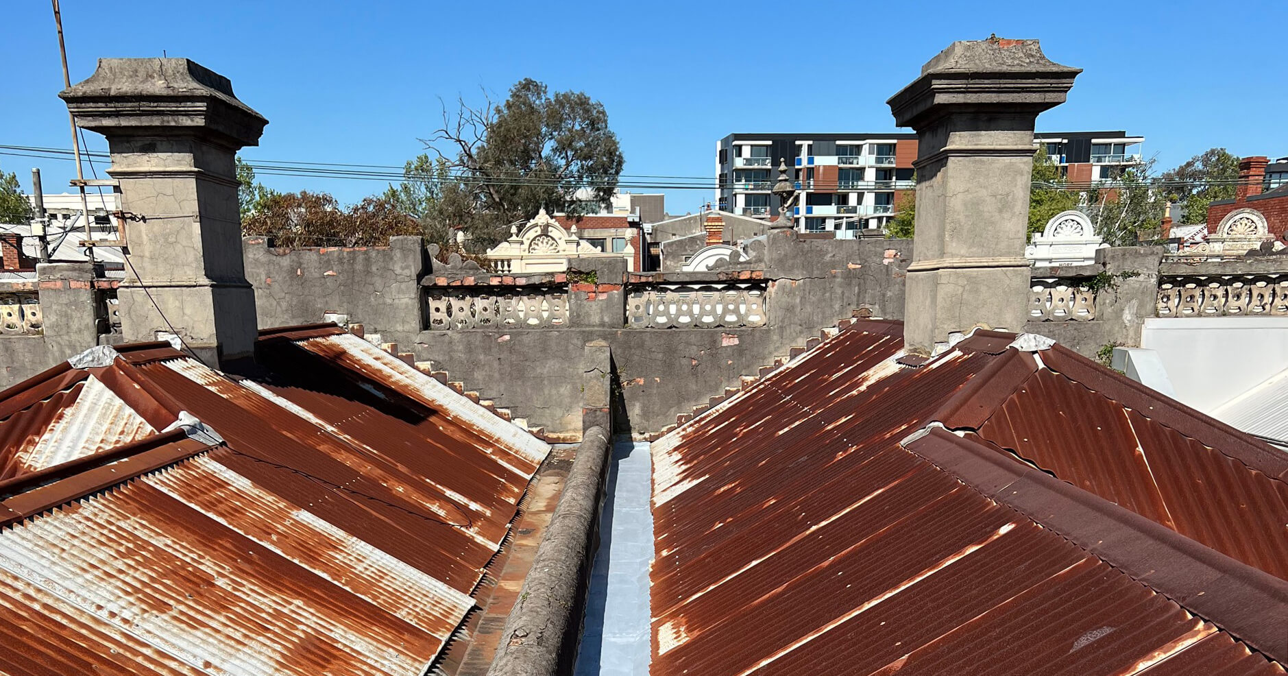 rusty corregated roof plumbing pitch gutter fitzroy inner north