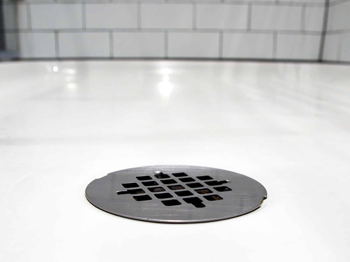 A close-up of a drain in the bathroom