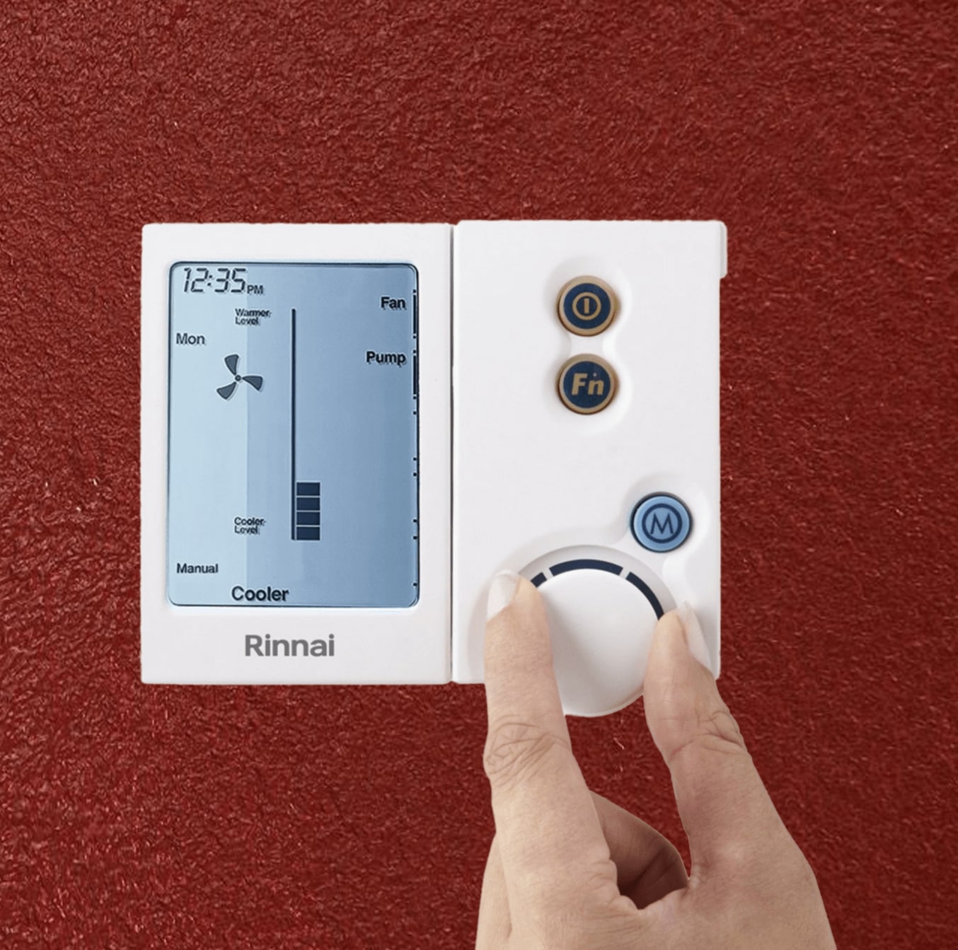 thermostat rinnai on a red painted wall with a hand using it